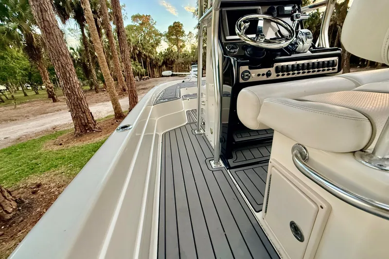 Slide: The Image of 2012 ShearWater 25LTZ boat interior with sleek design and modern steering console. - 59