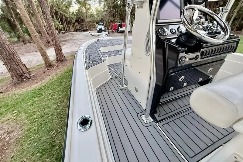 Slide: The Image of 2012 ShearWater 25LTZ boat with sleek deck and modern steering console. - 60