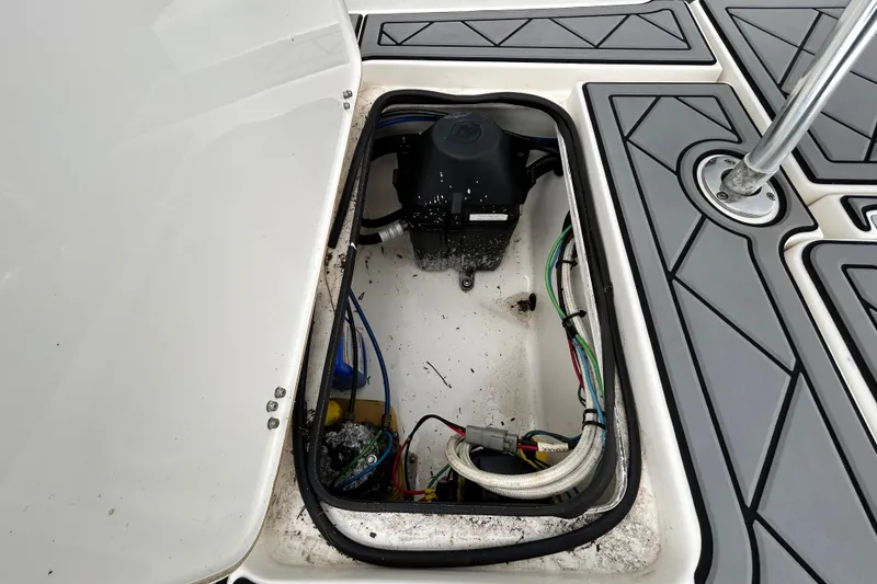 Slide: The Image of Open hatch of a 2012 ShearWater 25 LTZ boat showing internal wiring and components. - 65