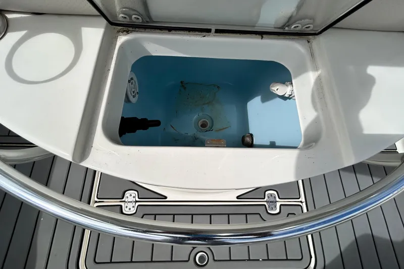 Slide: The Image of Livewell compartment on a 2012 ShearWater 25 LTZ boat, featuring a clean interior. - 71