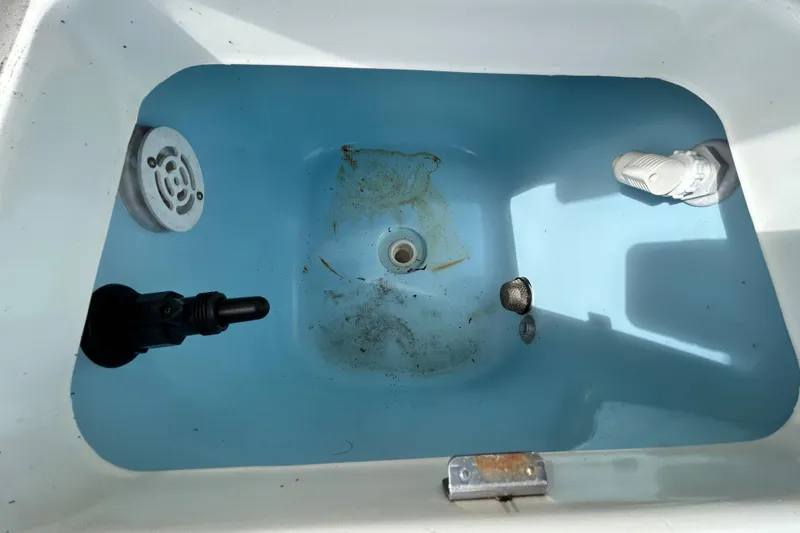 Slide: The Image of Livewell interior of a 2012 ShearWater 25 LTZ boat, showing water and drainage components. - 72