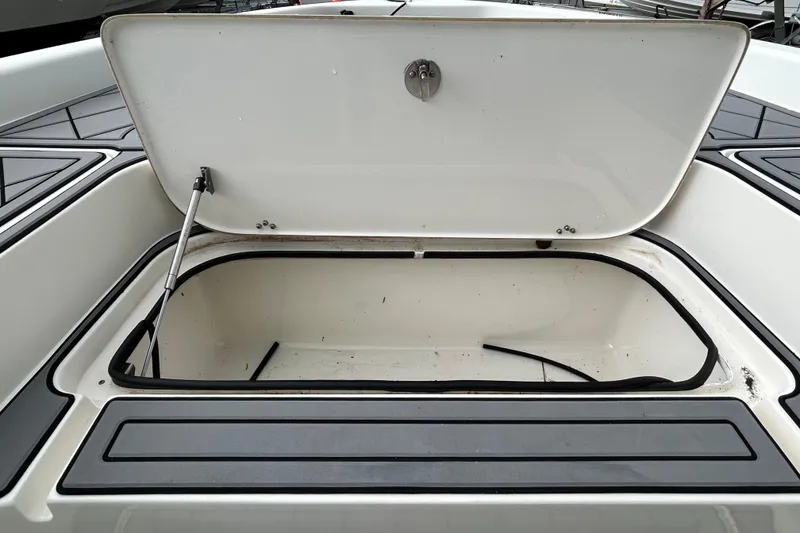 Slide: The Image of Open storage compartment on a 2012 ShearWater 25 LTZ boat. - 78