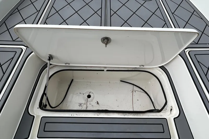 Slide: The Image of Open storage compartment on 2012 ShearWater 25 LTZ boat deck. - 79