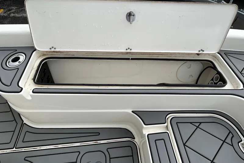 Slide: The Image of Open storage compartment on a 2012 ShearWater 25 LTZ boat deck. - 81
