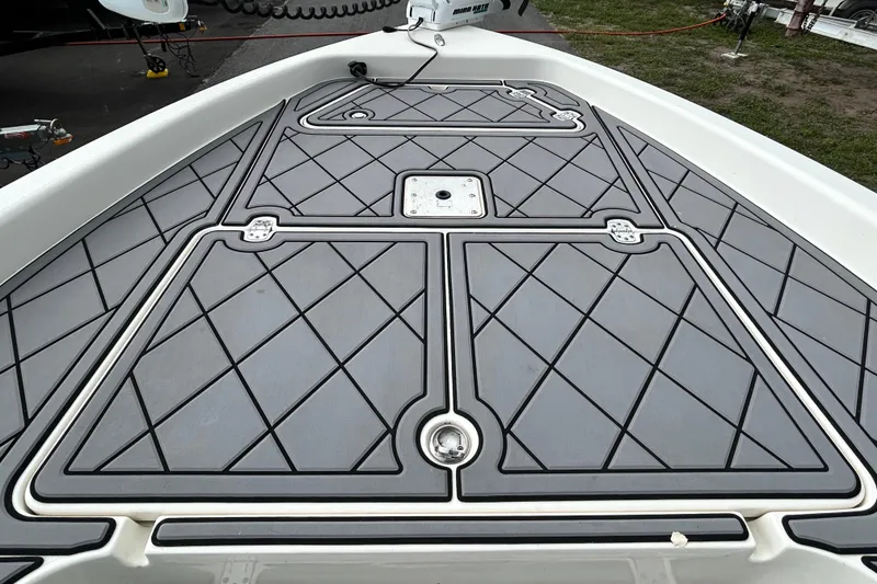 Slide: The Image of Bow deck of a 2012 ShearWater 25 LTZ boat with diamond-patterned flooring. - 83