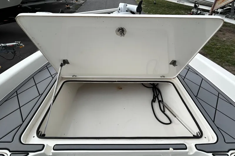 Slide: The Image of Open storage compartment on a 2012 ShearWater 25 LTZ boat, showcasing interior space. - 84