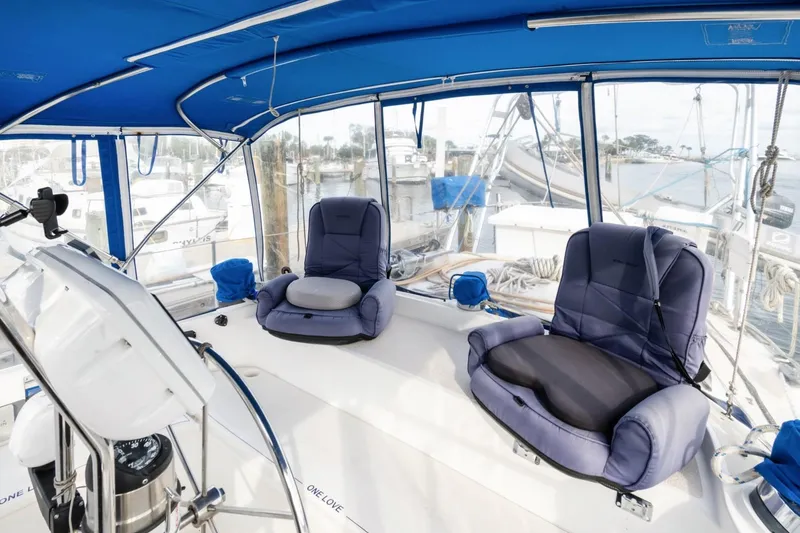 Slide: The Image of 1987 Morgan 41 Out Island Classic yacht cockpit with blue cushioned seats and canopy. - 10