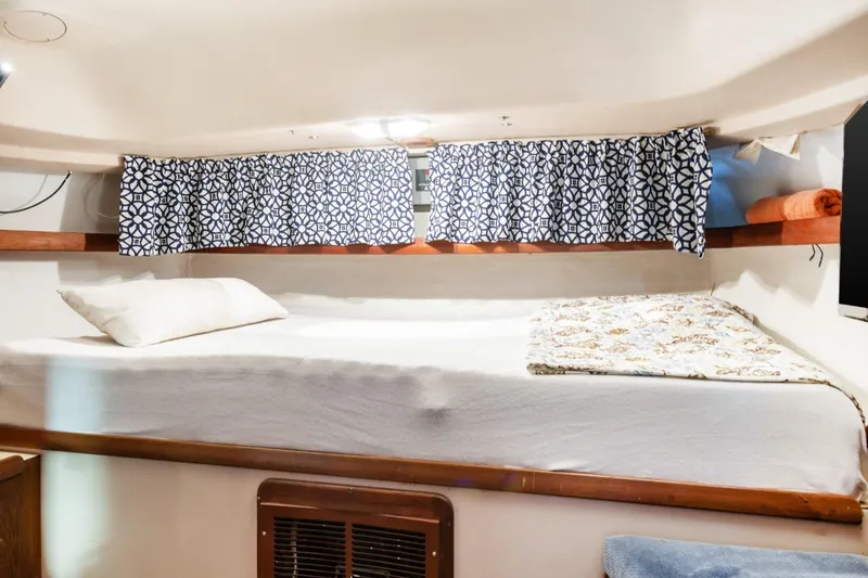 Slide: The Image of Cozy cabin interior of 1987 Morgan 41 Out Island Classic sailboat with patterned curtains. - 15