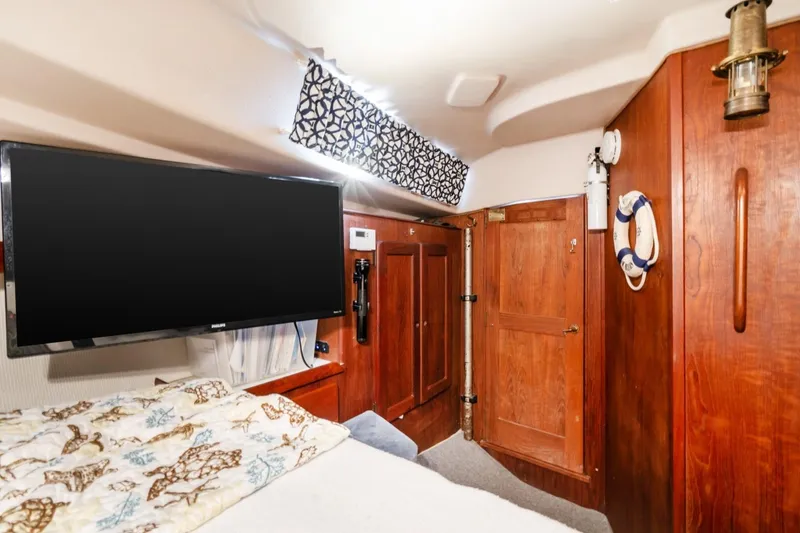 Slide: The Image of Interior of 1987 Morgan 41 Out Island Classic yacht with wood paneling and mounted TV. - 17