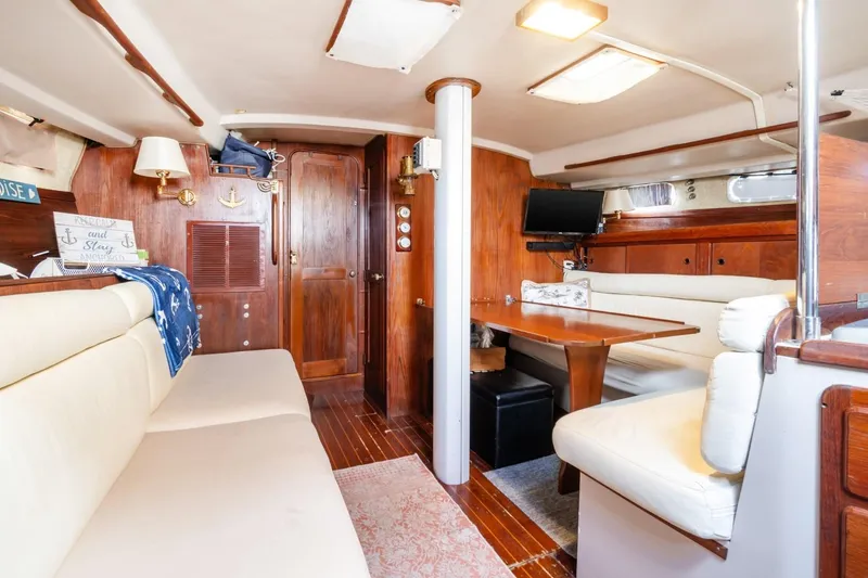 Slide: The Image of Interior of 1987 Morgan 41 Out Island Classic yacht with cozy seating and wooden finishes. - 18
