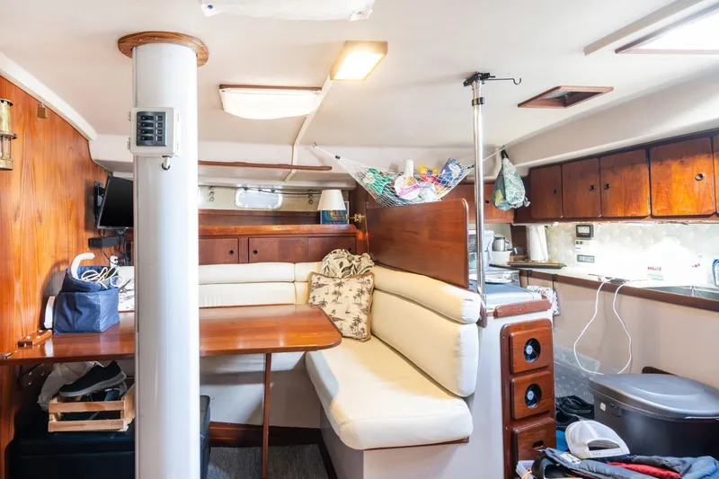 Slide: The Image of Interior of 1987 Morgan 41 Out Island Classic yacht with cozy seating and wooden cabinetry. - 20