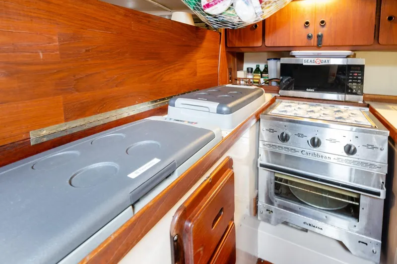 Slide: The Image of Galley kitchen in 1987 Morgan 41 Out Island Classic yacht with stove and storage. - 26