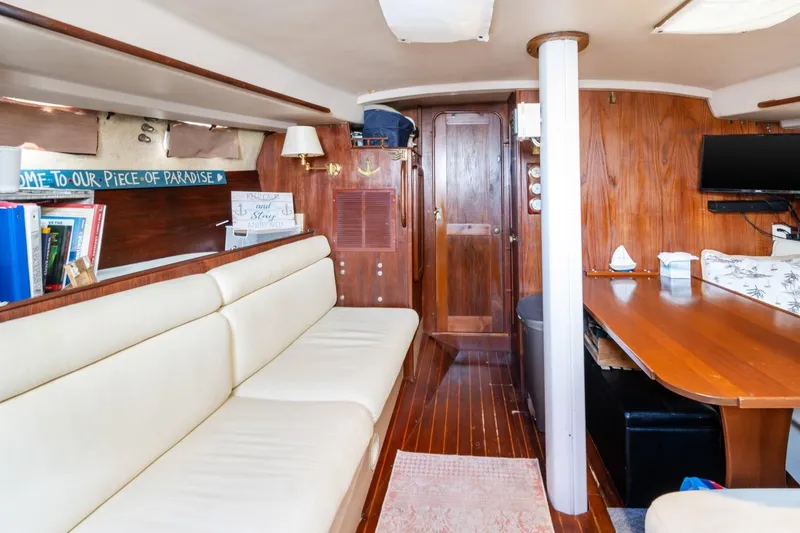 Slide: The Image of Interior of 1987 Morgan 41 Out Island Classic yacht with cozy seating and wooden decor. - 29