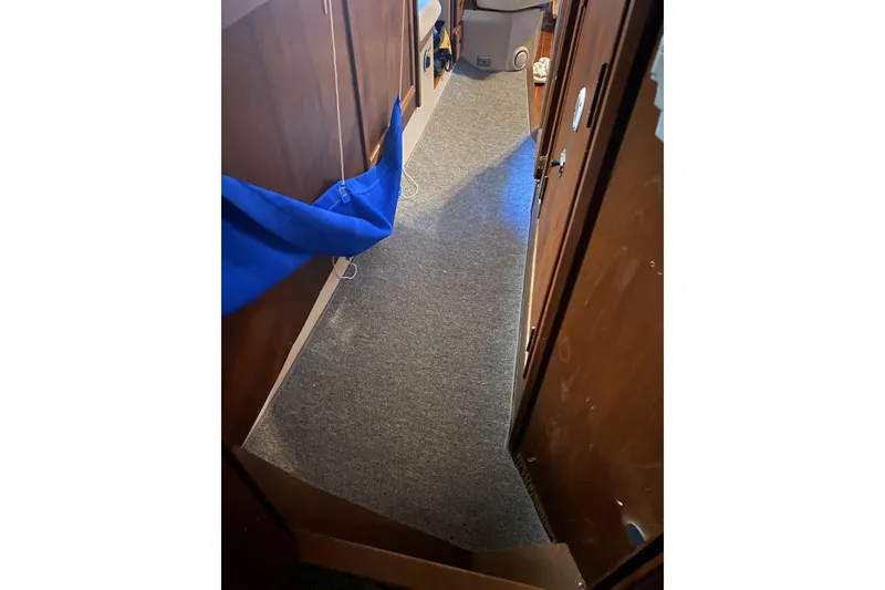 Slide: The Image of Interior hallway of 1987 Morgan 41 Out Island Classic sailboat with carpet and wood paneling. - 34