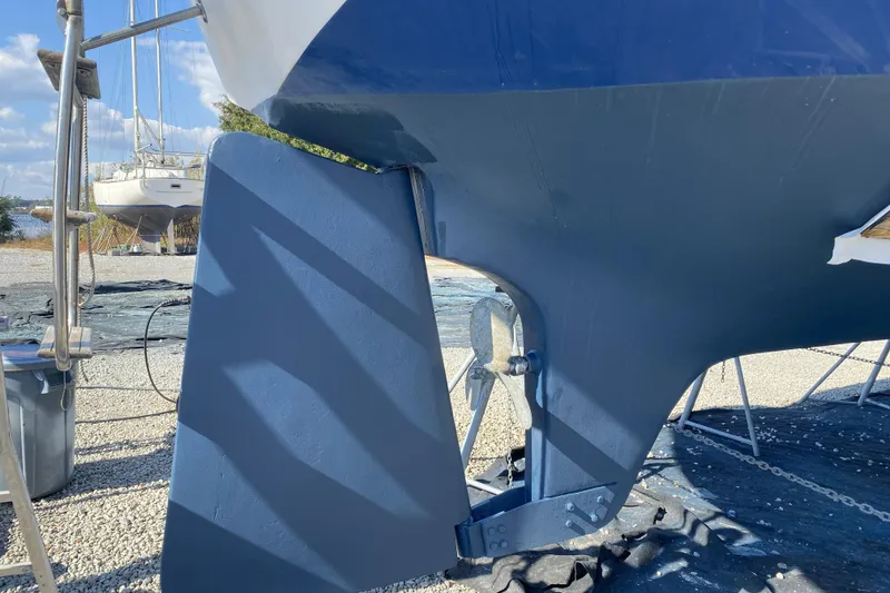 Slide: The Image of 1987 Morgan 41 Out Island Classic sailboat hull and rudder in dry dock. - 41