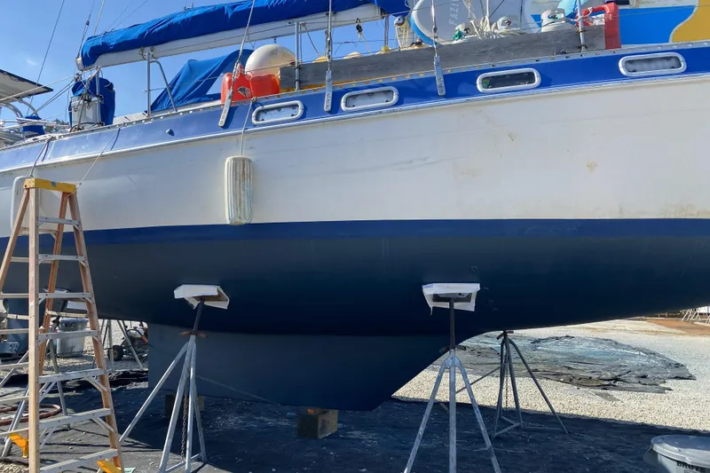 Slide: The Image of 1987 Morgan 41 Out Island Classic sailboat on stands, undergoing maintenance. - 42