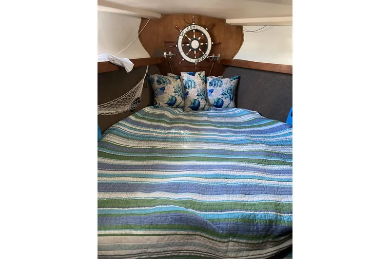 Slide: The Image of Cozy cabin interior of 1987 Morgan 41 Out Island Classic with striped bedding and nautical decor. - 46