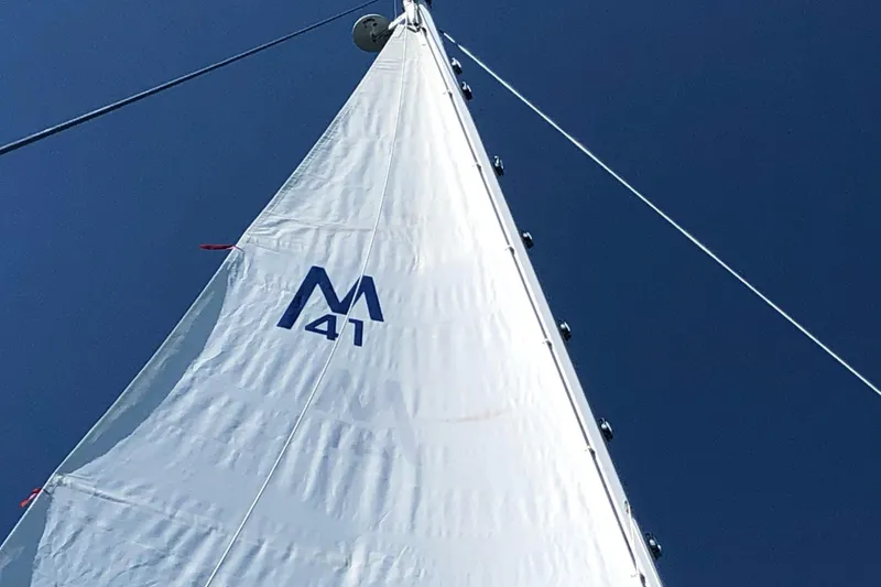 Slide: The Image of Sail of 1987 Morgan 41 Out Island Classic against clear blue sky. - 47