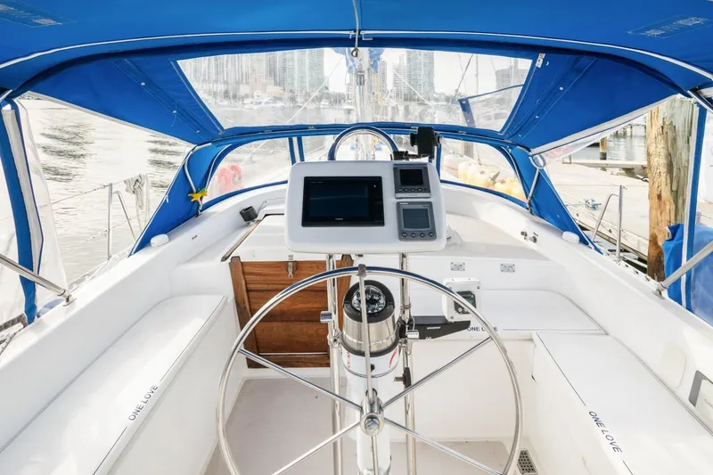 Slide: The Image of Cockpit of 1987 Morgan 41 Out Island Classic sailboat with blue canopy and navigation equipment. - 9