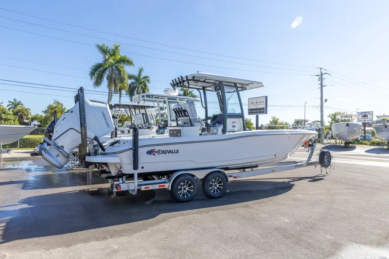 The Image of 2026 Crevalle 26 HCO boat on trailer, parked outdoors under clear sky. - 0