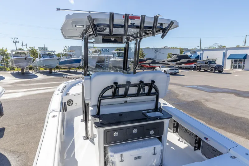 Slide: The Image of 2026 Crevalle 26 HCO boat with rod holders and storage, displayed outdoors. - 13