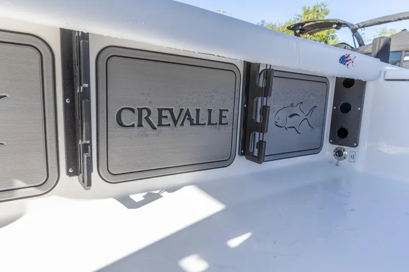 Slide: The Image of 2026 Crevalle 26 HCO boat interior with branded storage compartments. - 15