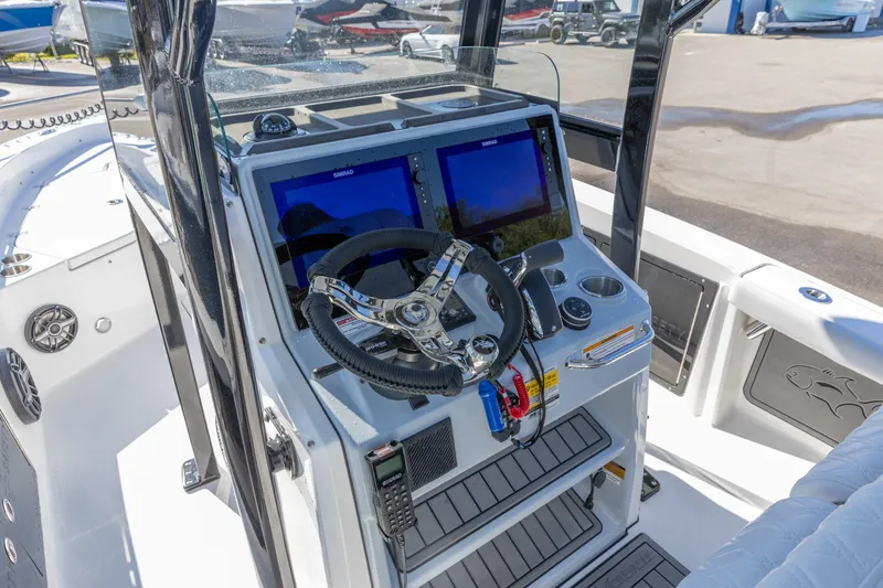 Slide: The Image of 2026 Crevalle 26 HCO boat dashboard with dual screens and steering wheel. - 16