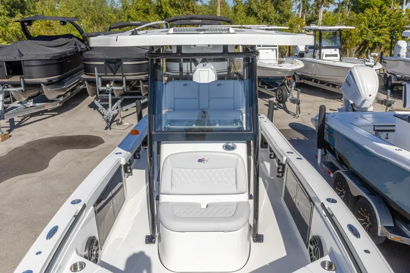 Slide: The Image of 2026 Crevalle 26 HCO boat in a marina, surrounded by other vessels. - 2