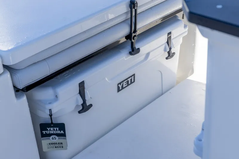 Slide: The Image of YETI cooler on 2026 Crevalle 26 HCO boat, secured with latches. - 23