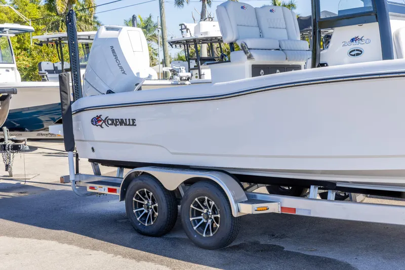 Slide: The Image of 2026 Crevalle 26 HCO boat on trailer, featuring Mercury engine, parked outdoors. - 27