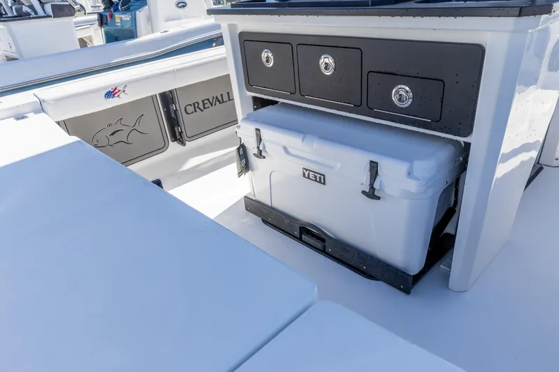 Slide: The Image of 2026 Crevalle 26 HCO boat interior with Yeti cooler and storage drawers. - 9