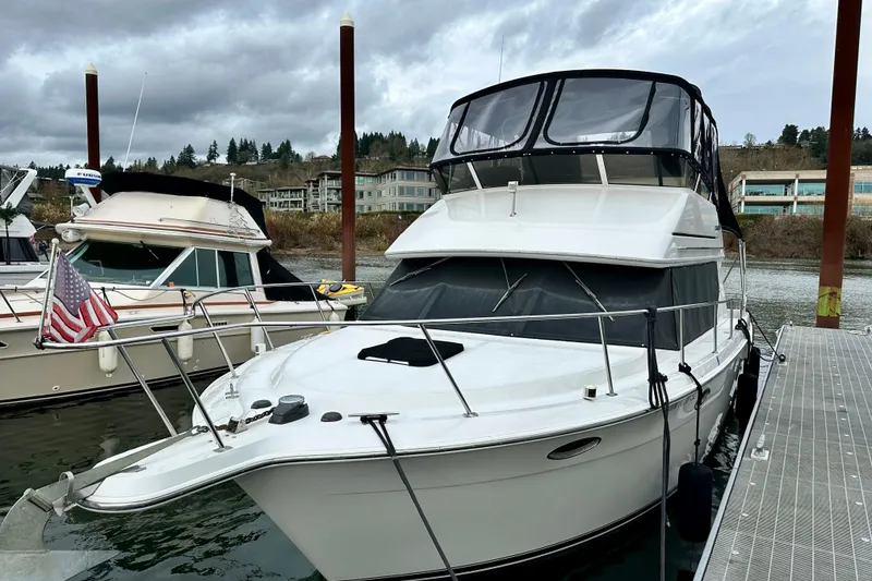 Slide: The Image of 1997 Carver 320 Voyager docked at marina under cloudy skies. - 14