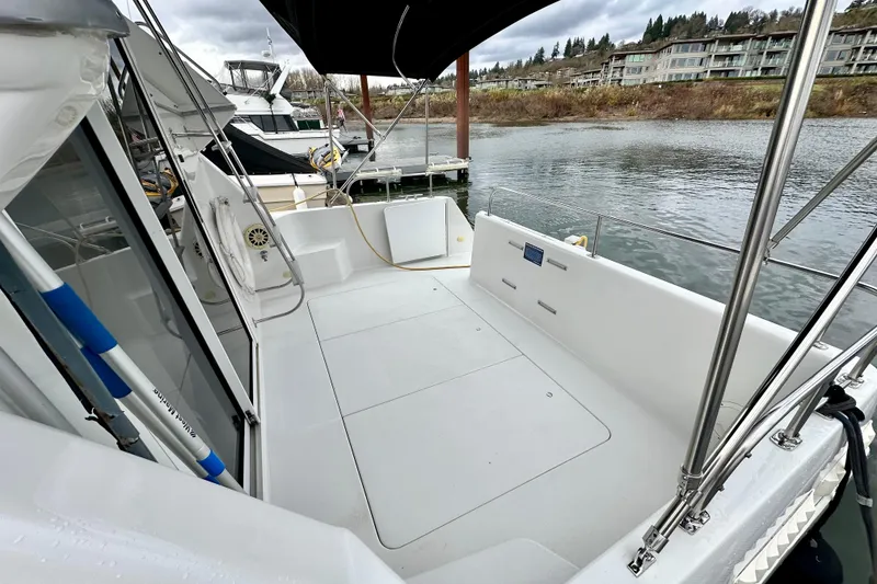 Slide: The Image of 1997 Carver 320 Voyager boat deck with marina view, featuring sleek design and spacious layout. - 16