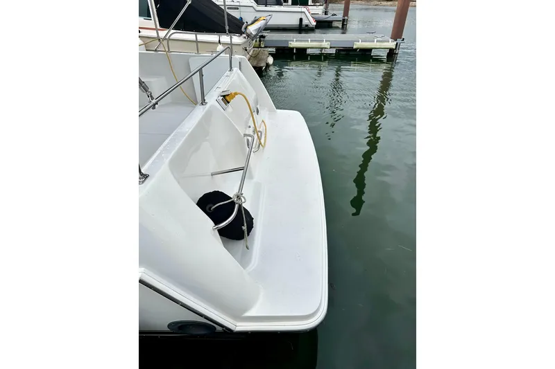 Slide: The Image of 1997 Carver 320 Voyager boat docked, featuring a clean white deck and railing. - 17