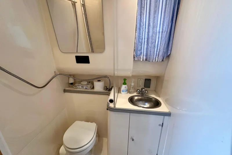 Slide: The Image of Bathroom of 1997 Carver 320 Voyager yacht with sink, toilet, and mirror. - 30