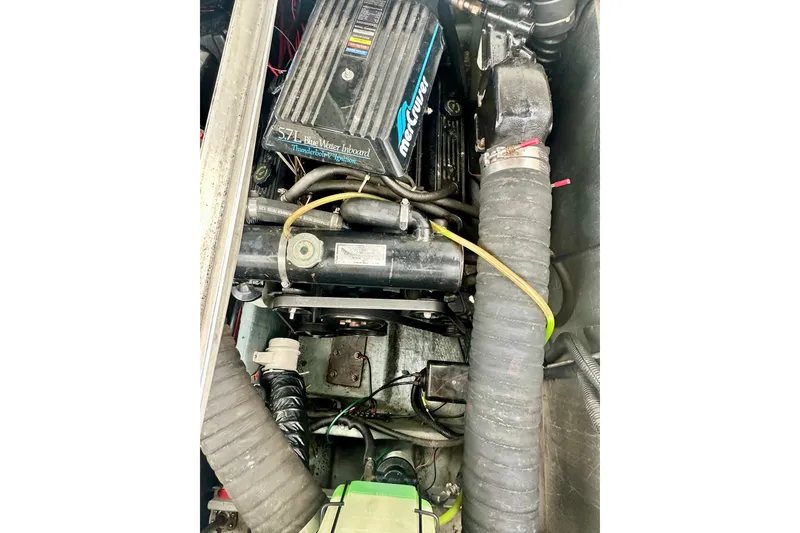 Slide: The Image of Engine compartment of a 1997 Carver 320 Voyager boat, featuring a 5.7L MerCruiser engine. - 34