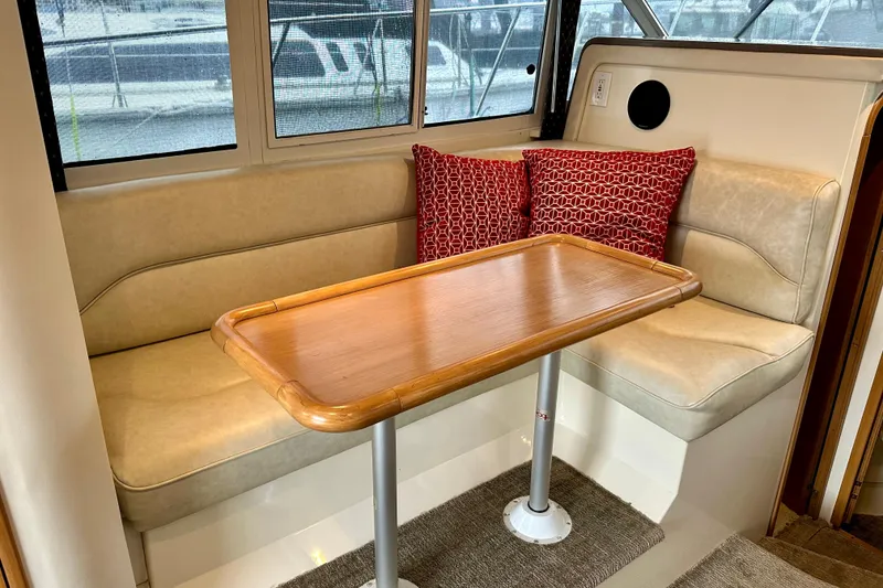 Slide: The Image of Interior of 1997 Carver 320 Voyager with beige seating and wooden table. - 5