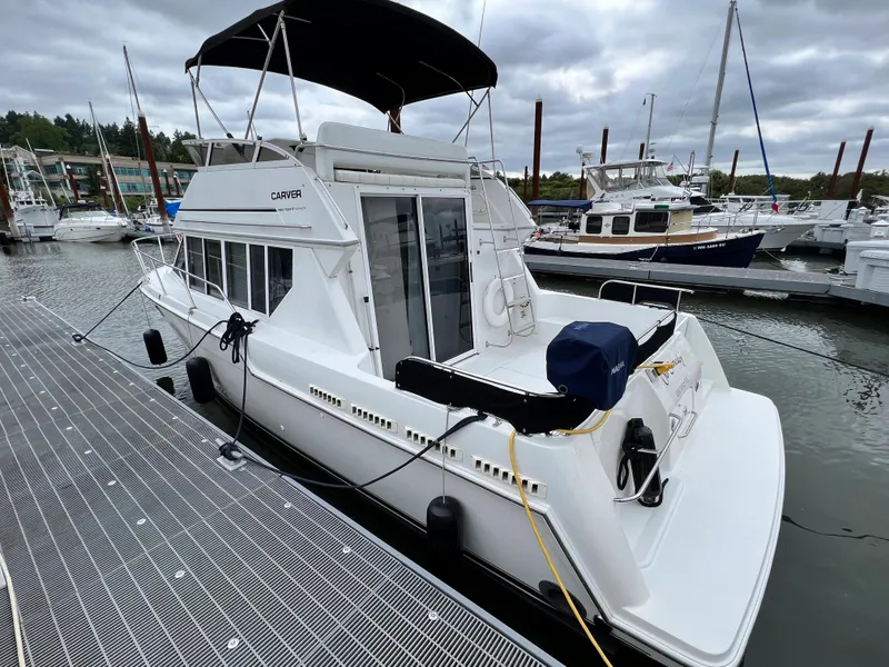 Slide: The Image of 1997 Carver 320 Voyager yacht docked at marina. - 8