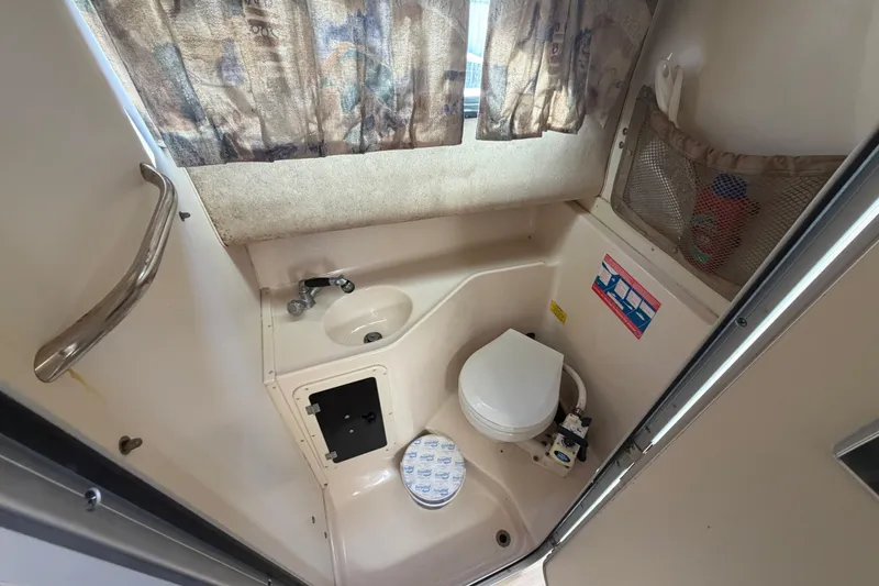 Slide: The Image of 2001 Grady-White Sailfish 282 boat bathroom with sink, toilet, and storage. - 14
