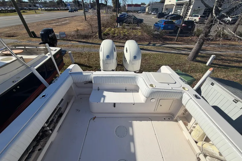 Slide: The Image of 2001 Grady-White Sailfish 282 boat deck with twin outboard engines, parked outdoors. - 4