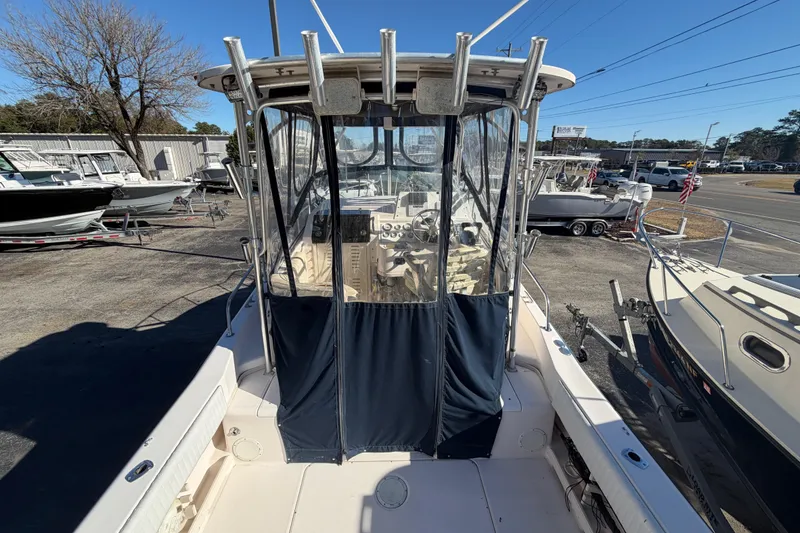 Slide: The Image of 2001 Grady-White Sailfish 282 boat docked, featuring a covered cockpit area. - 5