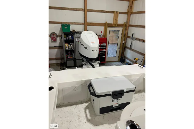 Slide: The Image of 2024 C-Hawk 23 Center Console boat with Honda 150 engine in a garage. - 10