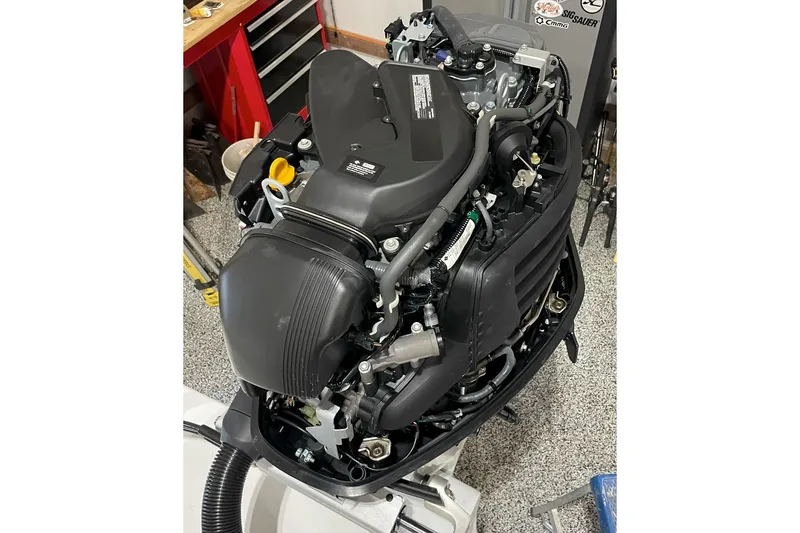 Slide: The Image of 2024 C-Hawk 23 Center Console engine, detailed view in workshop setting. - 11