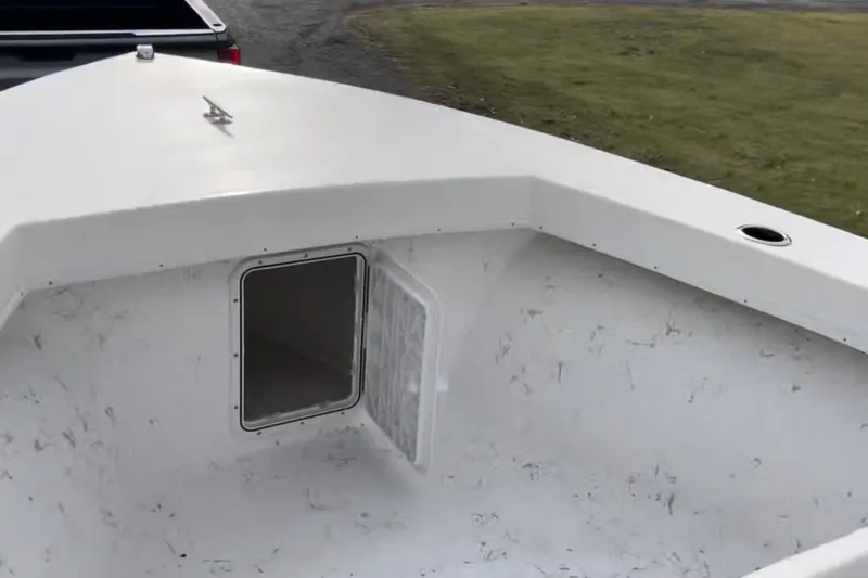 Slide: The Image of 2024 C-Hawk 23 Center Console boat interior with open storage compartment. - 5