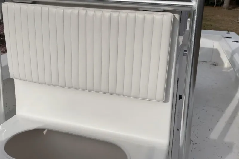 Slide: The Image of 2024 C-Hawk 23 Center Console boat with white cushioned seating. - 6