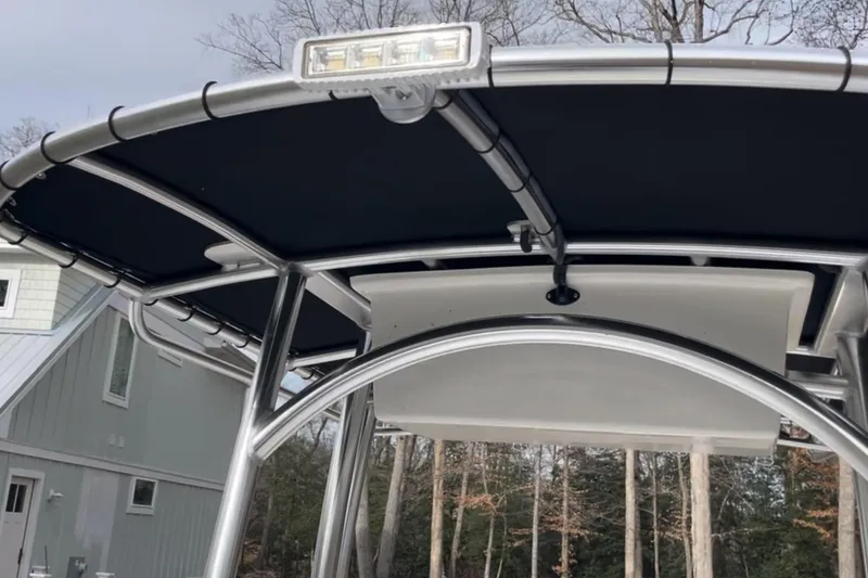 Slide: The Image of 2024 C-Hawk 23 Center Console T-top with LED light, outdoor setting. - 7