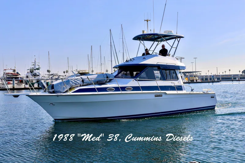 The Image of 1988 Mediterranean 38 Convertible yacht with Cummins Diesels in marina setting. - 0