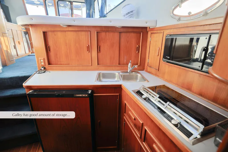 Slide: The Image of 1988 Mediterranean 38 Convertible yacht galley with ample storage, sink, and stove. - 17