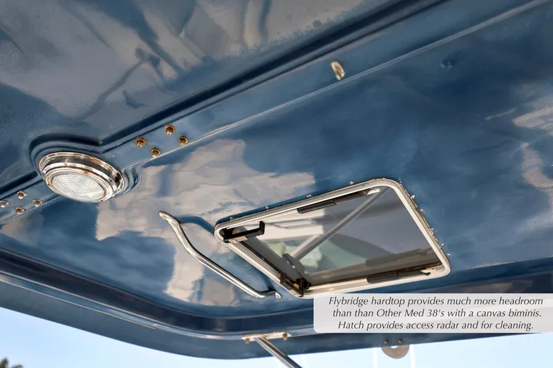 Slide: The Image of Flybridge hardtop of 1988 Mediterranean 38 Convertible with hatch and light fixture. - 6