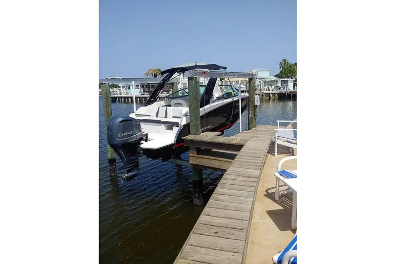 Slide: The Image of 2017 Regal 23 OBX boat docked with Yamaha outboard motor, sunny waterfront setting. - 3